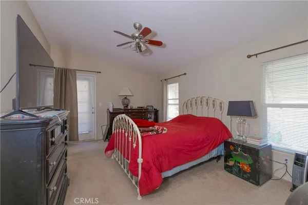 a bed room with a bed and a television
