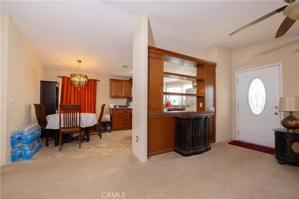 a view of a dining room with furniture and a chandelier