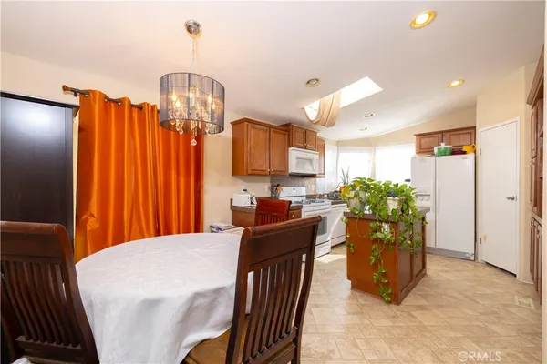 a kitchen with stainless steel appliances granite countertop a refrigerator a stove and a wooden cabinets