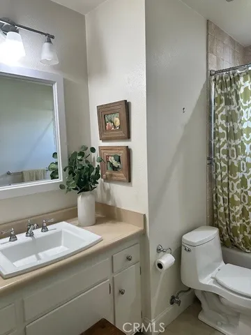 a bathroom with a sink toilet and mirror