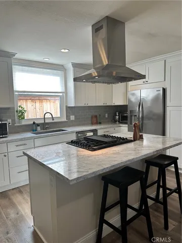 a kitchen with a stove a sink and a refrigerator