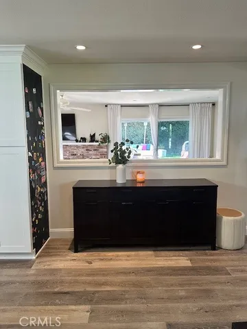 a living room with a fireplace and a large window