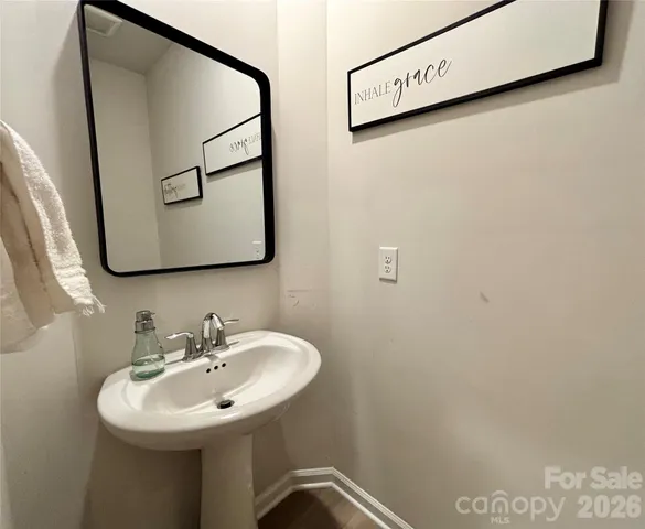 a bedroom with a bed and a flat tv screen on the dresser