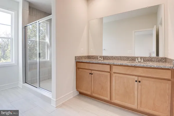 a bathroom with a shower and a bath tub