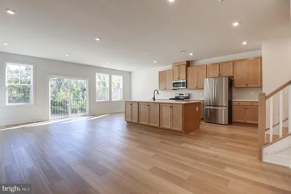 a kitchen with wooden cabinets and stainless steel appliances