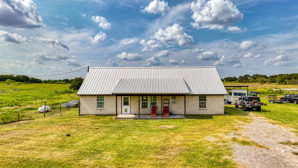 11500 Bowden Road Lipan, TX 76462 - Photo 19 of 32 a view of a house with a swimming pool and a yard