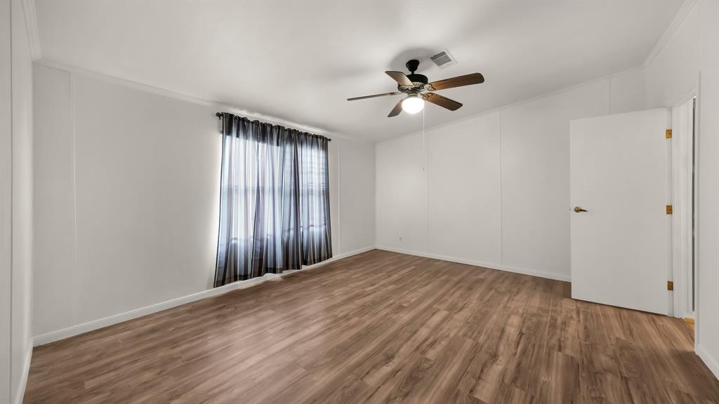 11500 Bowden Road Lipan, TX 76462 - Photo 30 of 32 a view of empty room with wooden floor and fan