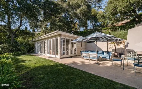 a view of a house with backyard and sitting area