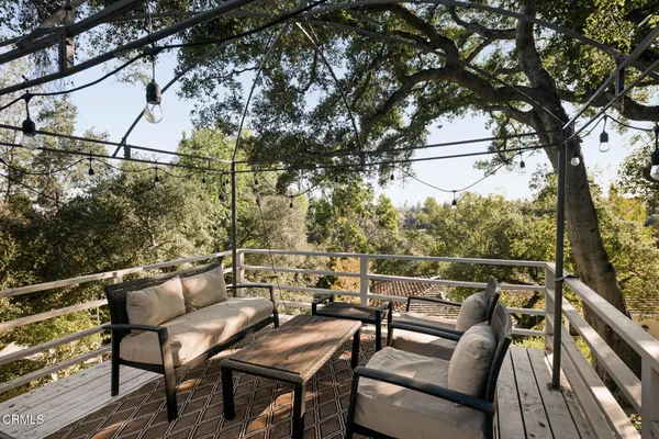 a view of a chairs and table in the balcony