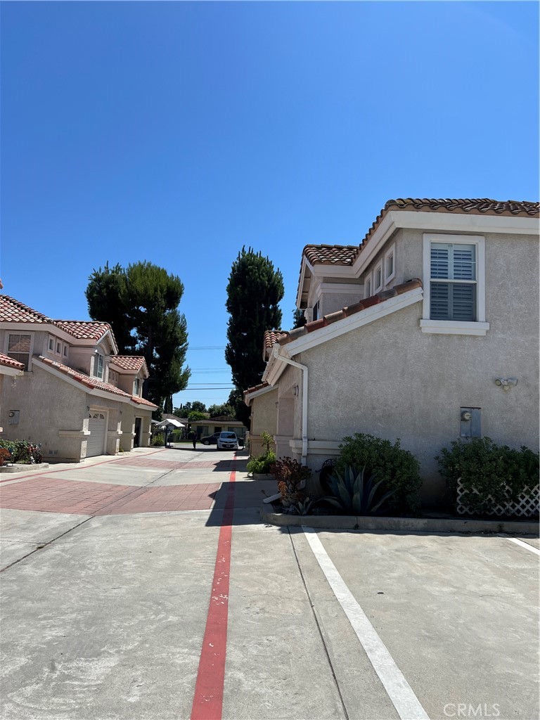 12143 Ferris Road El Monte, CA 91732 - Photo 8 of 18 a pathway of a house with potted plants