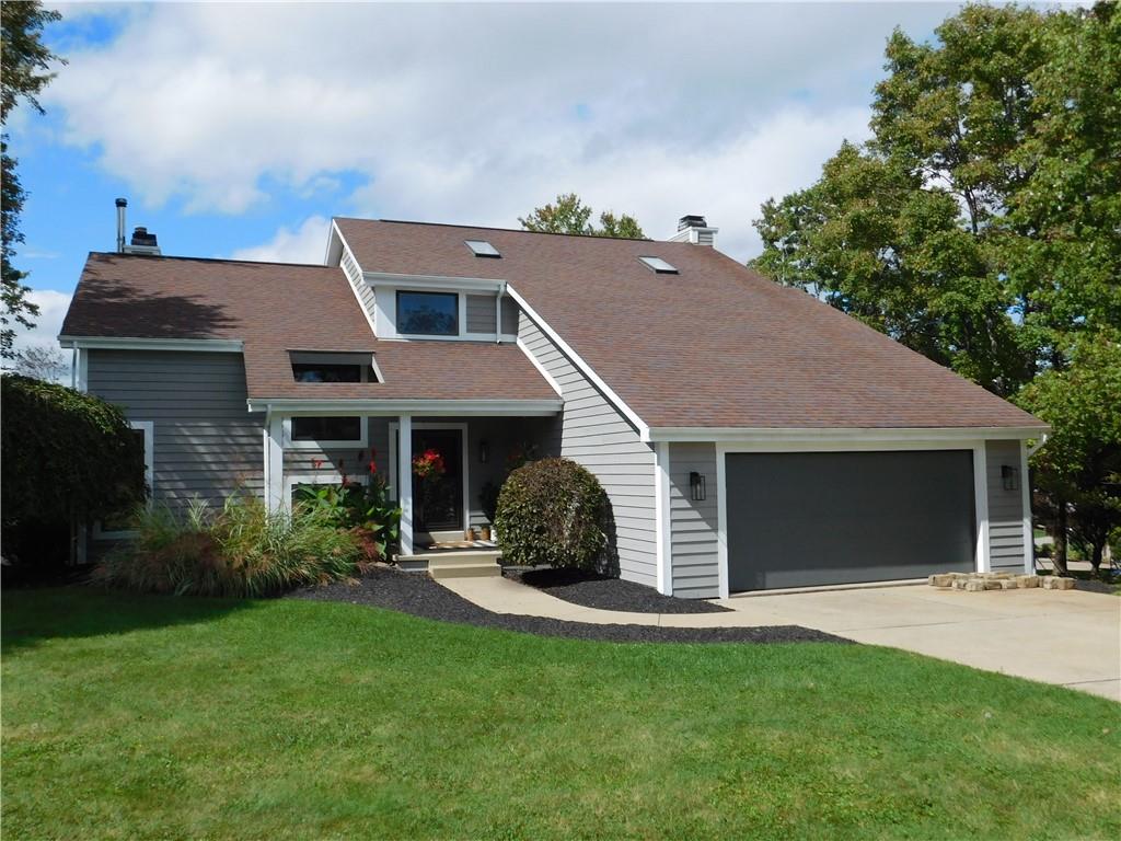a aerial view of a house next to a yard and potted plants