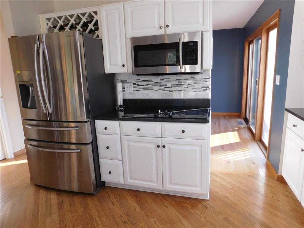 195 Finnin Road Lower Burrell, PA 15068 - Photo 11 of 21 a kitchen with granite countertop a refrigerator and a stove top oven