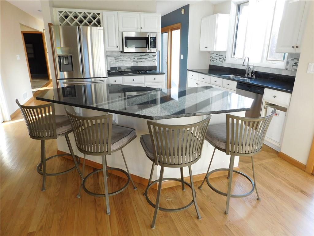 195 Finnin Road Lower Burrell, PA 15068 - Photo 9 of 21 a kitchen with stainless steel appliances granite countertop a table chairs and a refrigerator