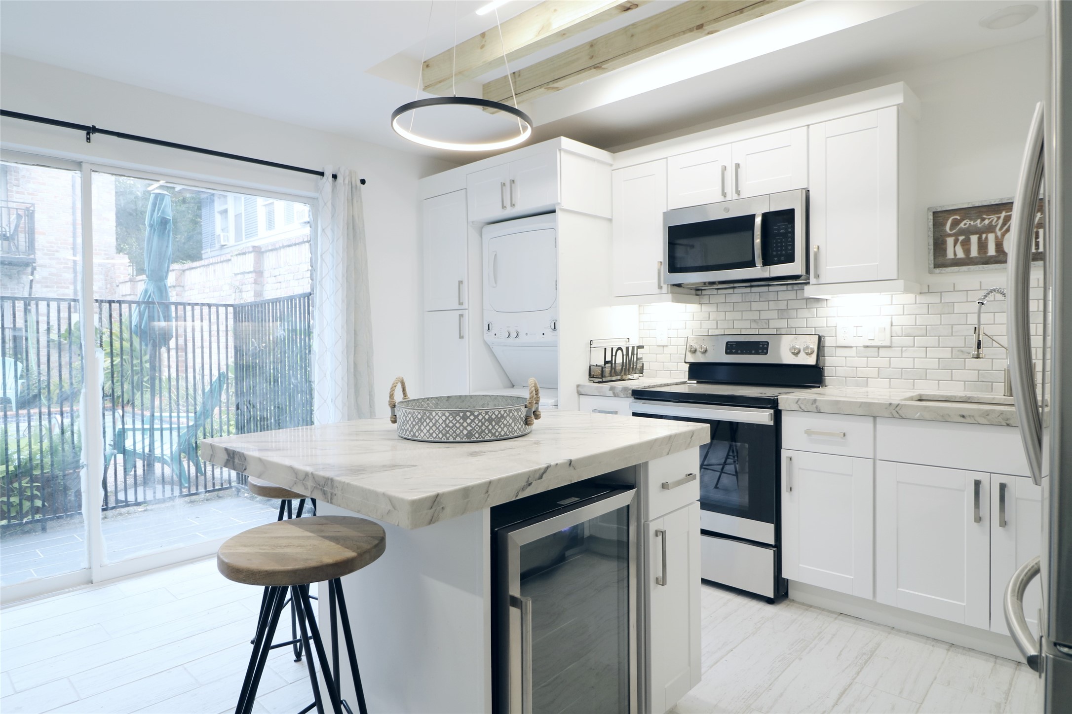 412 Pacific Street, Unit 2G Houston, TX 77006 - Photo 2 of 14 a kitchen with stainless steel appliances granite countertop a stove a sink and a microwave