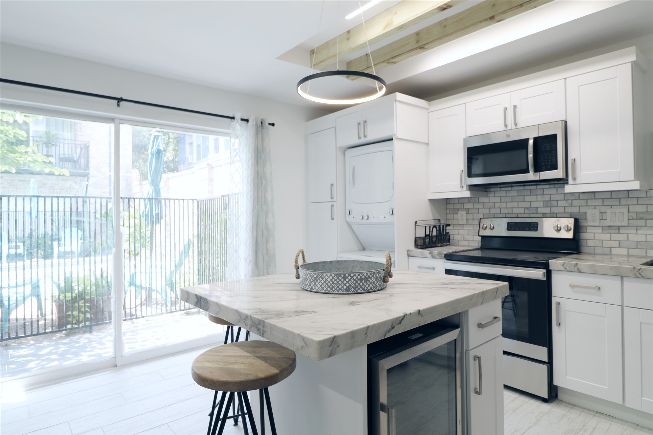 412 Pacific Street, Unit 2G Houston, TX 77006 - Photo 4 of 14 a kitchen with stainless steel appliances granite countertop a stove a sink a microwave a dining table and chairs