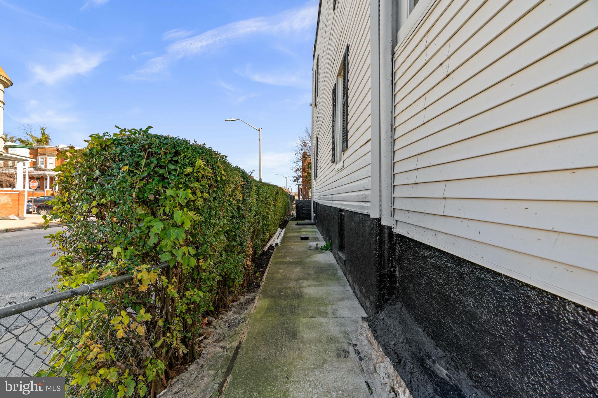 1542 Appleton Street Baltimore, MD 21217 - Photo 5 of 12 a pathway of a house with a yard