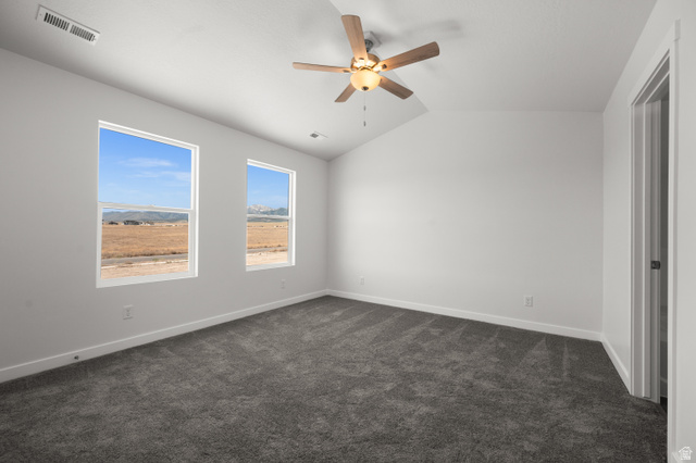 1554 Pheasant Road Eagle Mountain, UT 84005 - Photo 16 of 29 Unfurnished bedroom with lofted ceiling, dark colored carpet, and ceiling fan