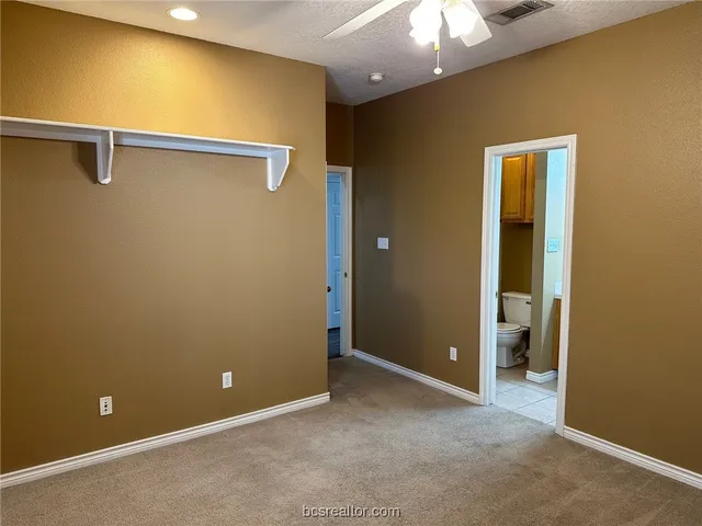 a view of an empty room with a fan