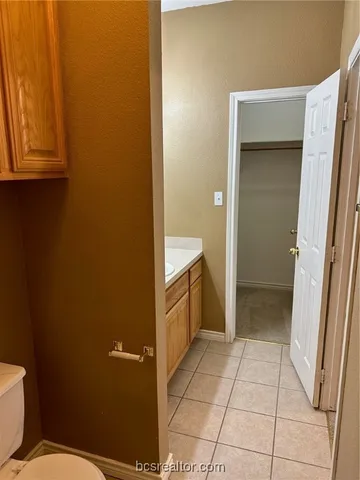 a bathroom with a sink a toilet and vanity