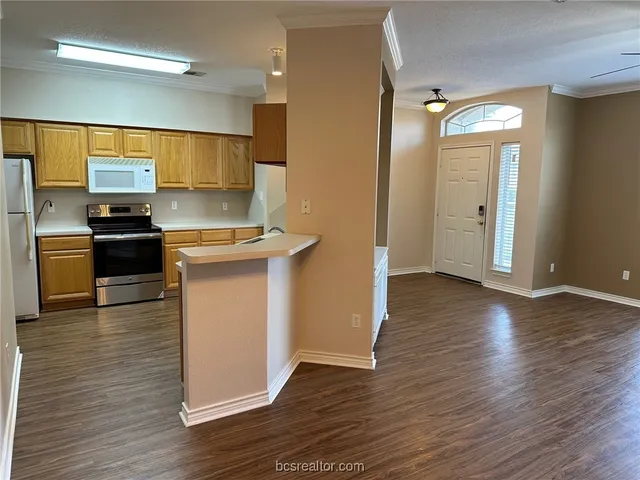 a kitchen with stainless steel appliances a stove top oven a sink and a refrigerator