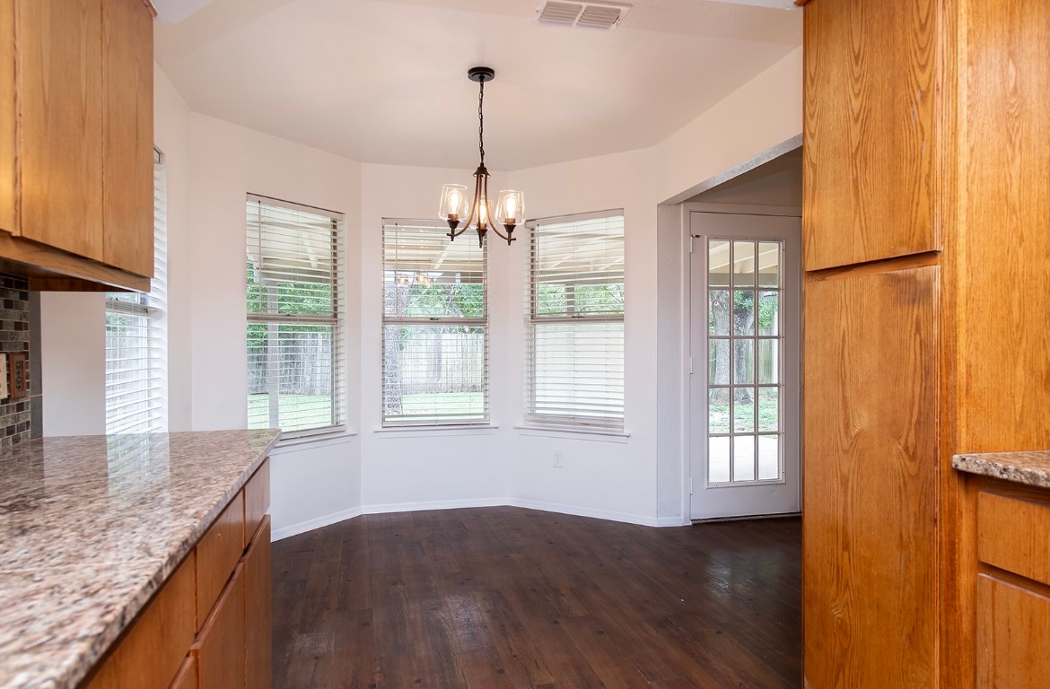 910 Garden View Drive Georgetown, TX 78628 - Photo 12 of 28 a view of an empty room with a window and wooden floor
