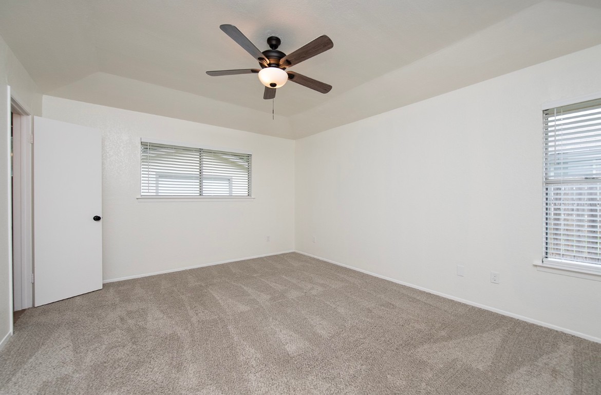 910 Garden View Drive Georgetown, TX 78628 - Photo 16 of 28 an empty room with windows and fan