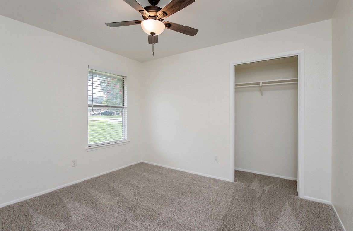 910 Garden View Drive Georgetown, TX 78628 - Photo 21 of 28 an empty room with windows and fan