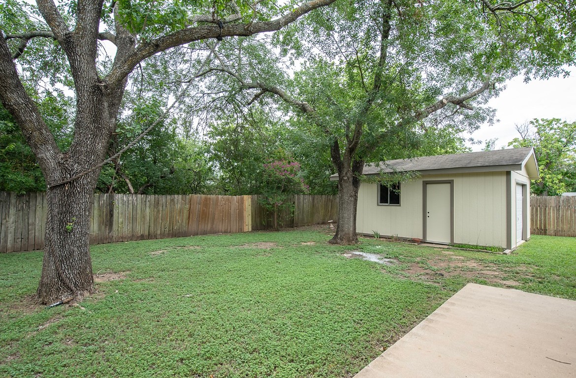910 Garden View Drive Georgetown, TX 78628 - Photo 24 of 28 a view of a house with a yard and large trees