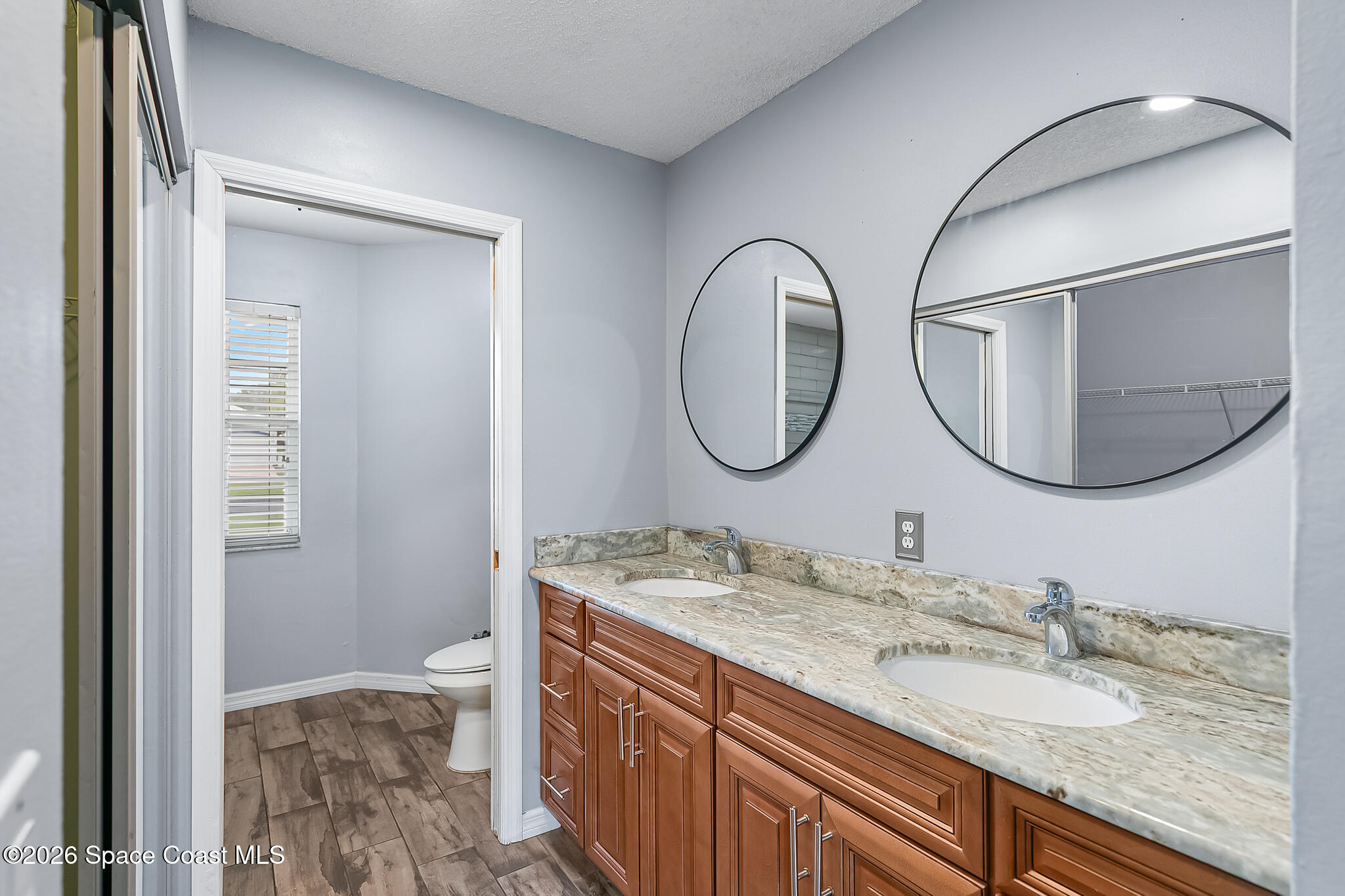 865 Dewberry Terrace Northeast Palm Bay, FL 32905 - Photo 10 of 29 a bathroom with a granite countertop double vanity sink and a mirror