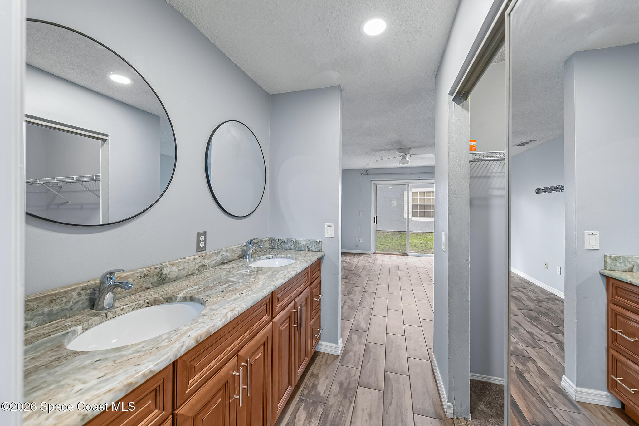865 Dewberry Terrace Northeast Palm Bay, FL 32905 - Photo 12 of 29 a en suite bathroom with a granite countertop double vanity sink and a mirror