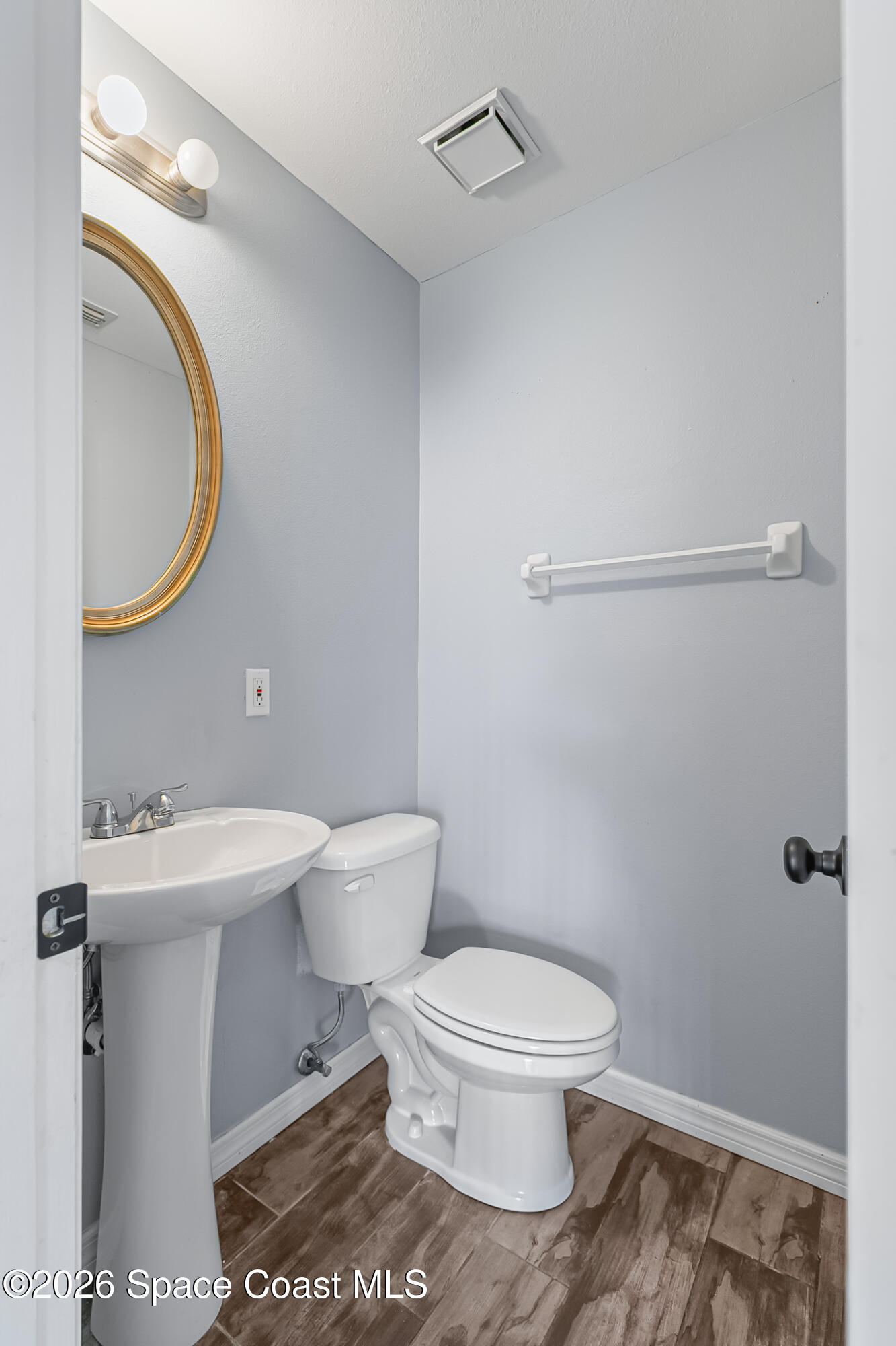 865 Dewberry Terrace Northeast Palm Bay, FL 32905 - Photo 14 of 29 a white toilet sitting next to a bathroom sink