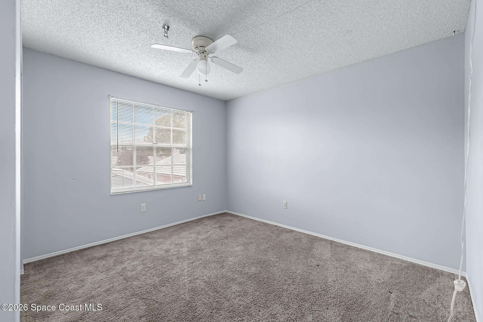 865 Dewberry Terrace Northeast Palm Bay, FL 32905 - Photo 15 of 29 an empty room with a window and a ceiling fan