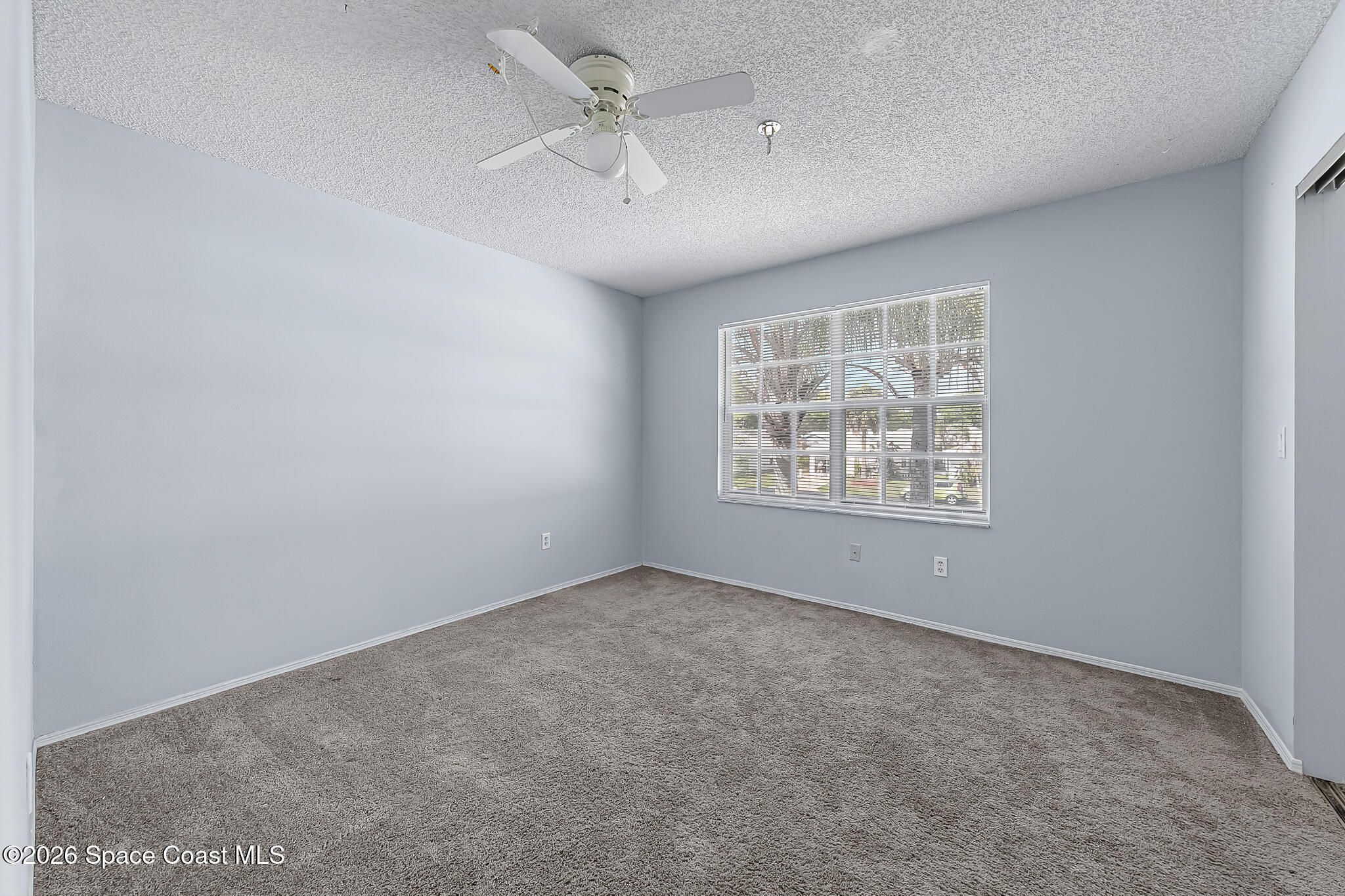 865 Dewberry Terrace Northeast Palm Bay, FL 32905 - Photo 17 of 29 an empty room with windows