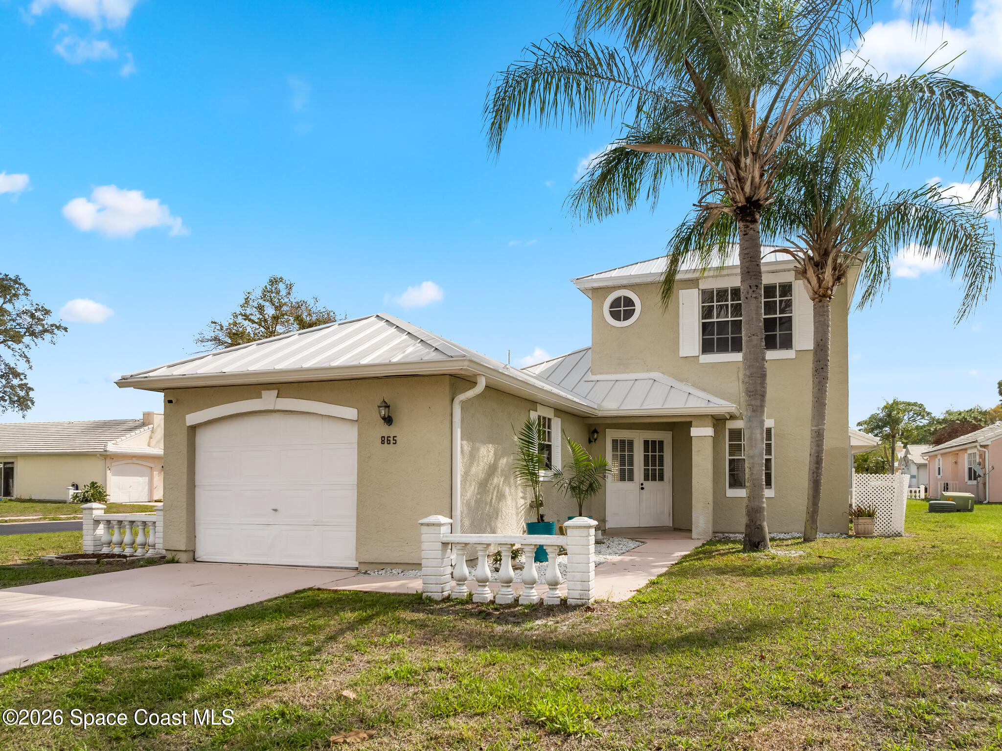 865 Dewberry Terrace Northeast Palm Bay, FL 32905 - Photo 18 of 29 a front view of a house with garden and patio