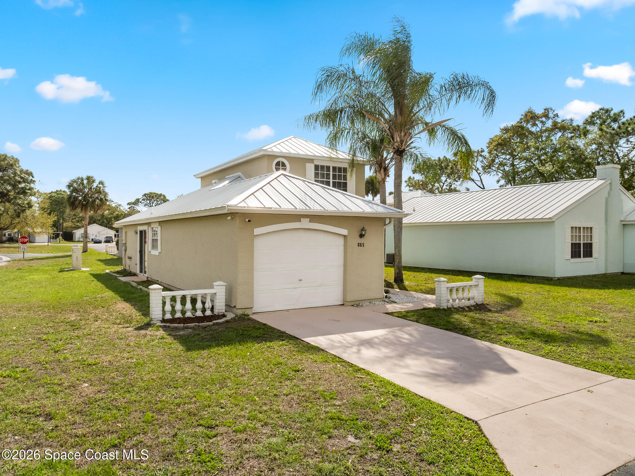 865 Dewberry Terrace Northeast Palm Bay, FL 32905 - Photo 19 of 29 a front view of a house with garden