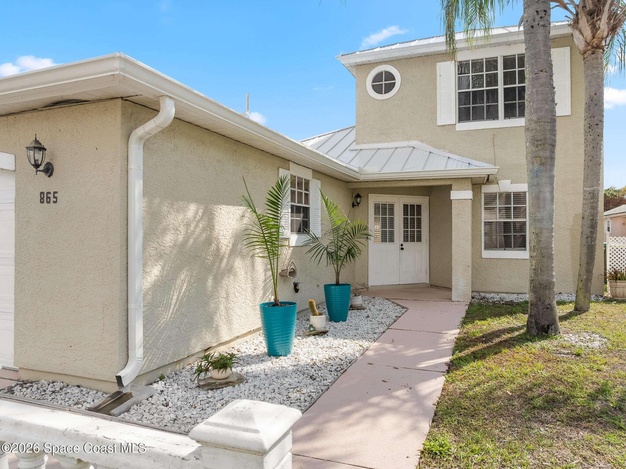 865 Dewberry Terrace Northeast Palm Bay, FL 32905 - Photo 2 of 29 a front view of a house with a yard