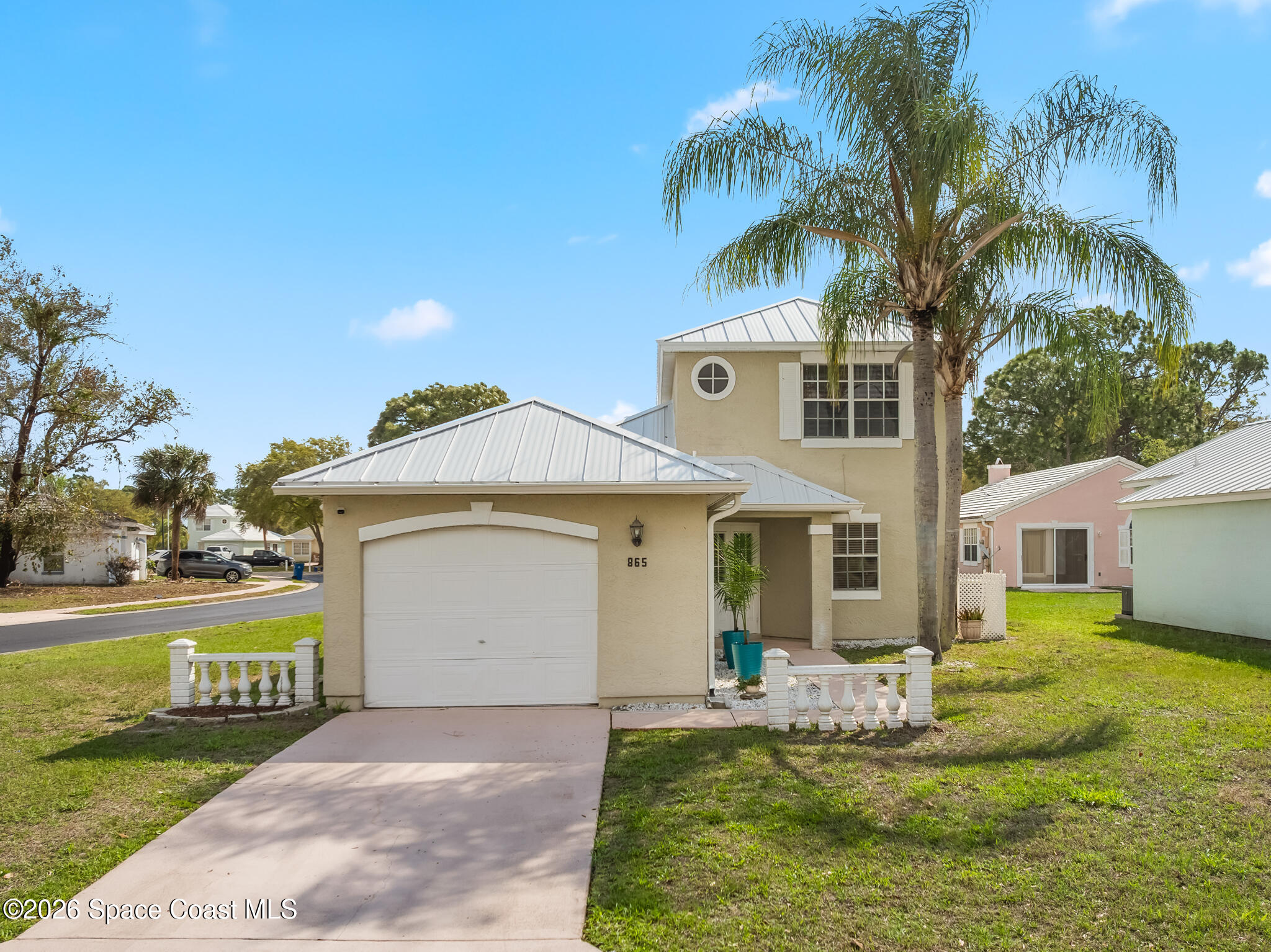 865 Dewberry Terrace Northeast Palm Bay, FL 32905 - Photo 20 of 29 a front view of a house with garden