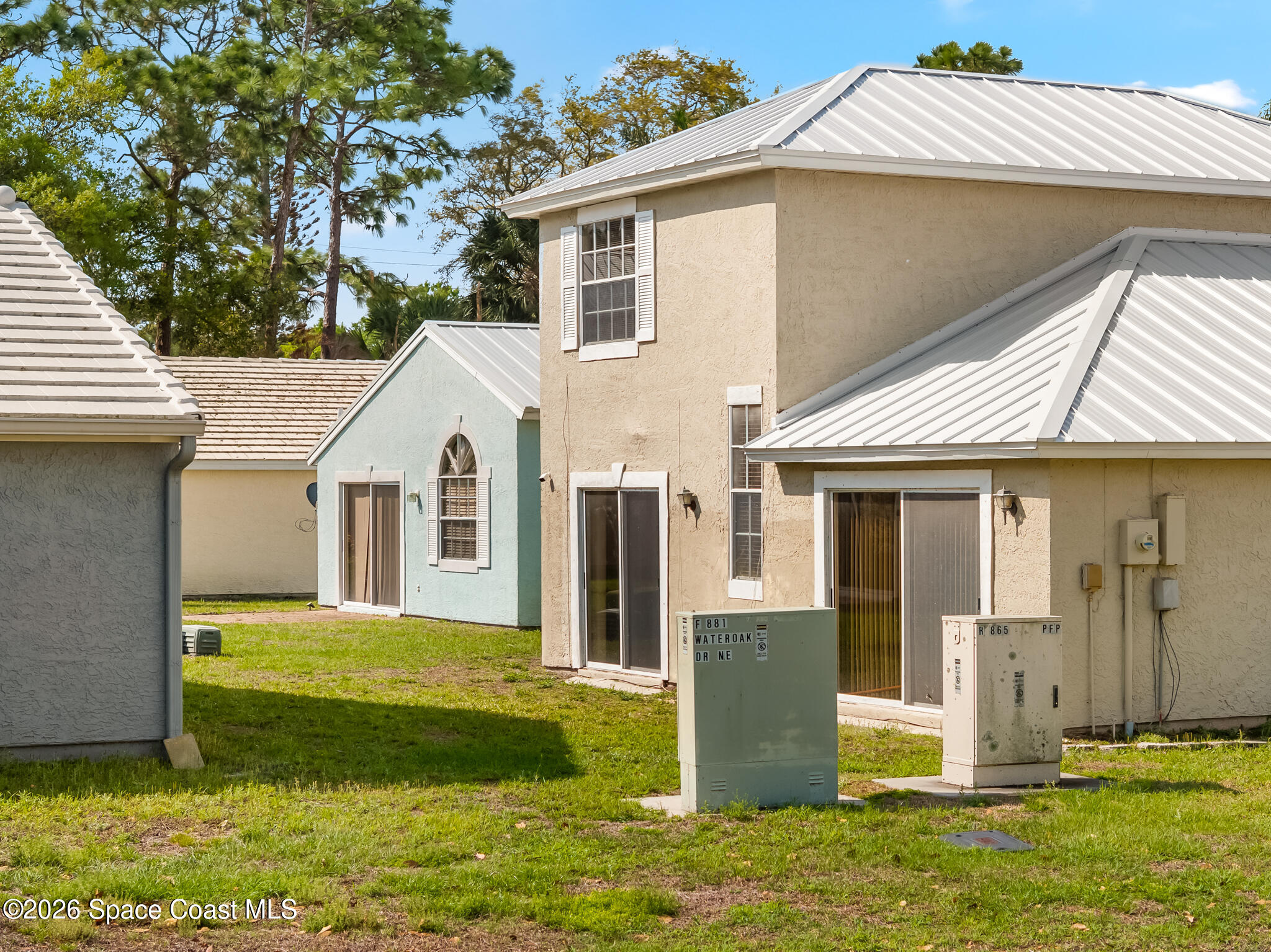 865 Dewberry Terrace Northeast Palm Bay, FL 32905 - Photo 21 of 29 a front view of a house with a yard