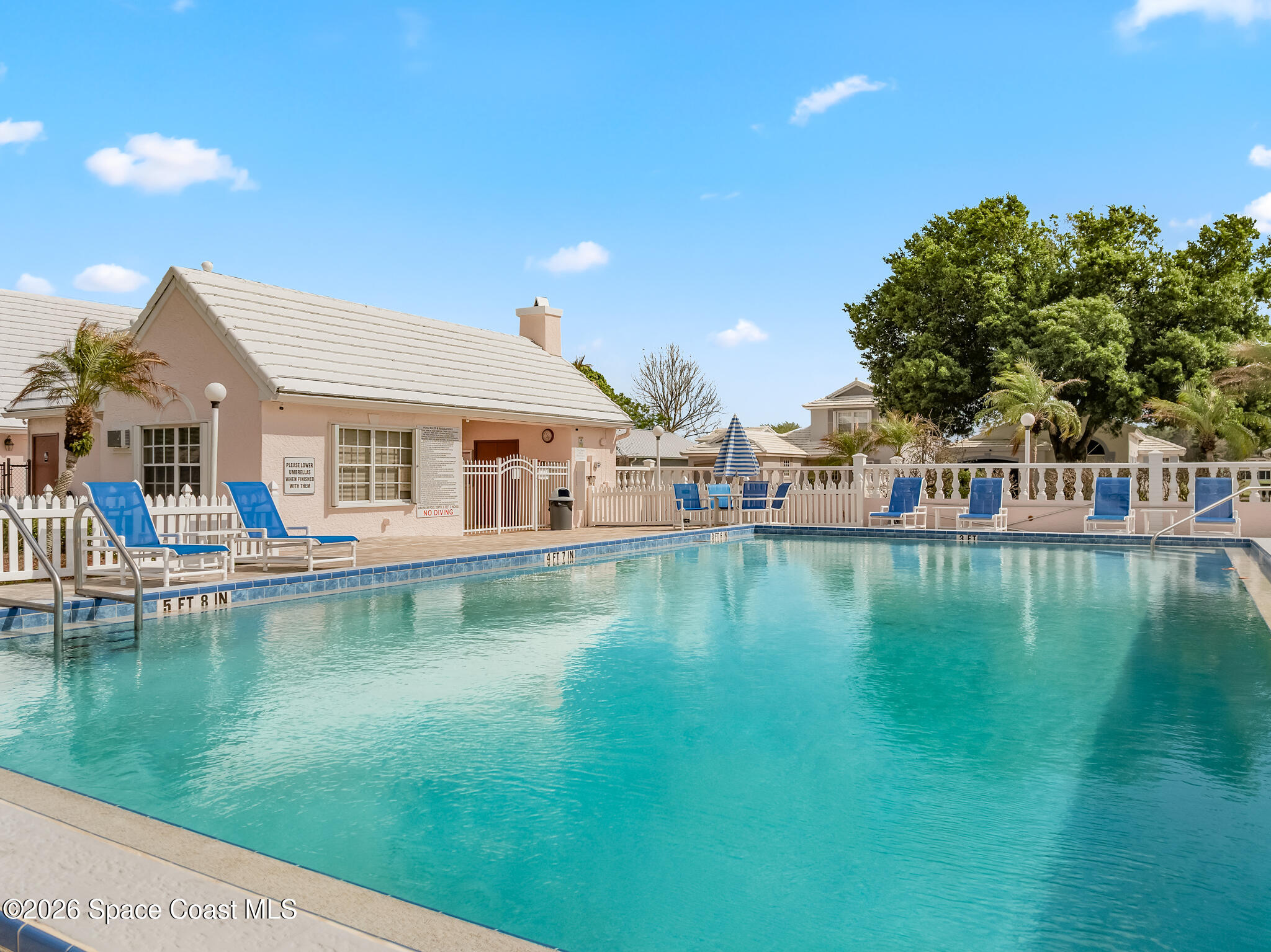 865 Dewberry Terrace Northeast Palm Bay, FL 32905 - Photo 25 of 29 a front view of a house with swimming pool and a yard