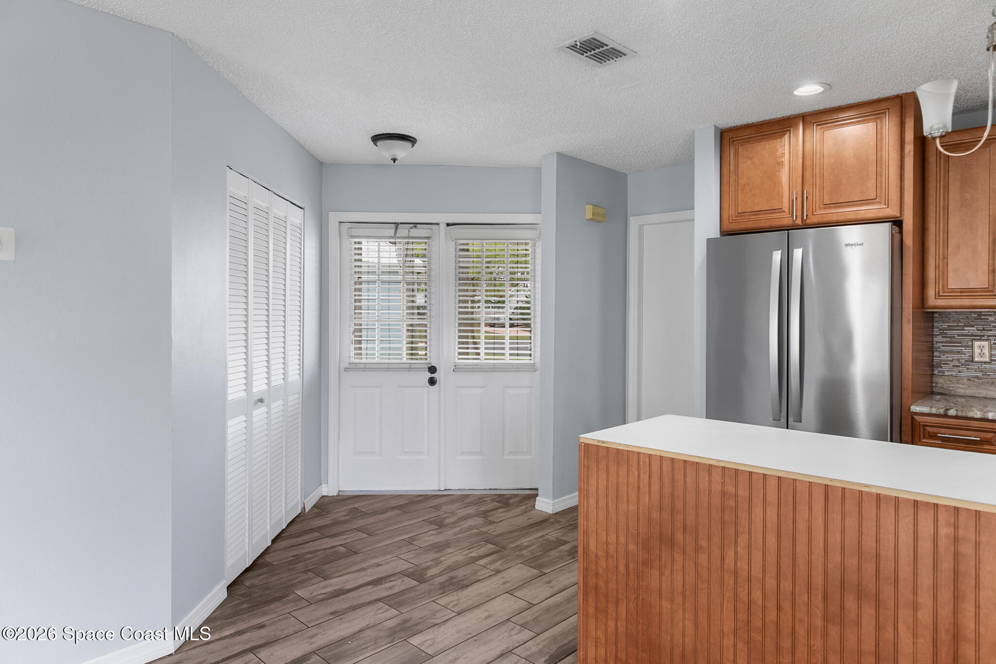 865 Dewberry Terrace Northeast Palm Bay, FL 32905 - Photo 6 of 29 a view of kitchen with wooden floor and refrigerator in it