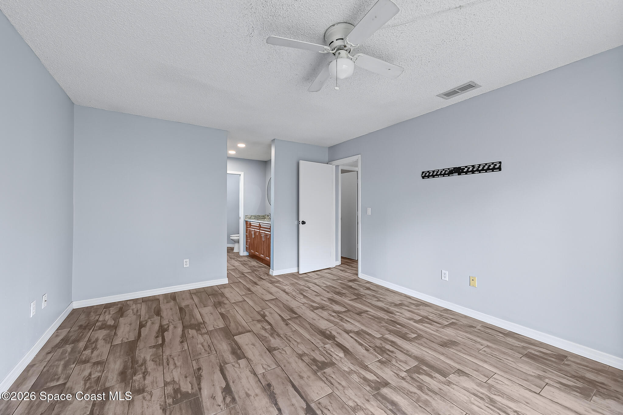 865 Dewberry Terrace Northeast Palm Bay, FL 32905 - Photo 9 of 29 a view of empty room with wooden floor
