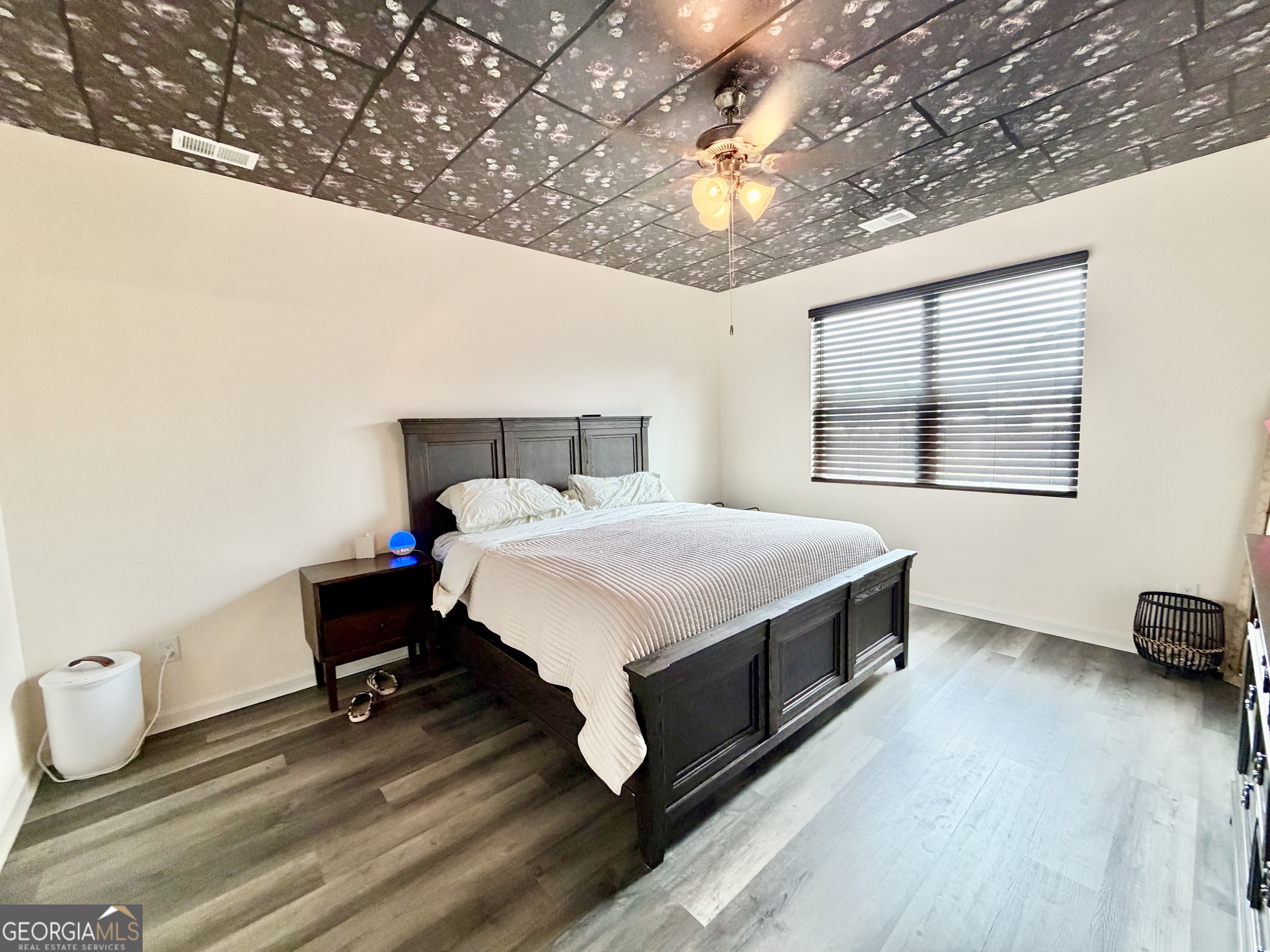 219 Barnyard Way Perry, GA 31069 - Photo 19 of 44 a bedroom with a bed and wooden floor
