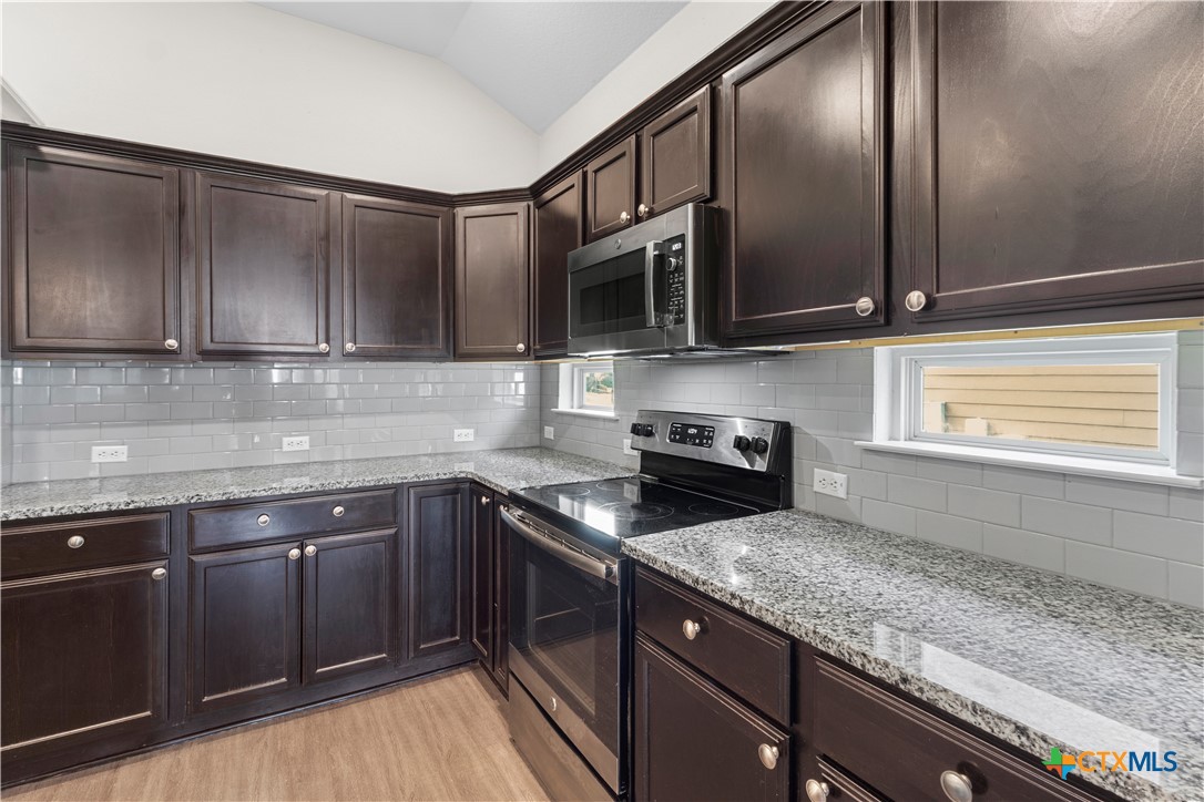 3615 Addison Street Killeen, TX 76542 - Photo 11 of 47 a kitchen with stainless steel appliances granite countertop a sink a stove and cabinets
