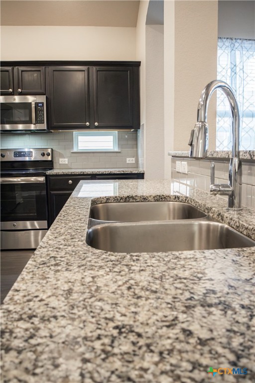 3615 Addison Street Killeen, TX 76542 - Photo 12 of 47 a view of a kitchen with kitchen island a sink stainless steel appliances and cabinets