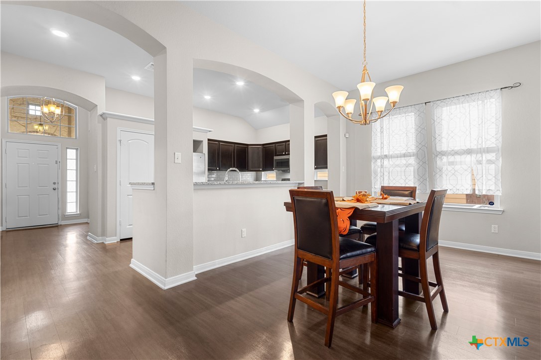 3615 Addison Street Killeen, TX 76542 - Photo 15 of 47 a view of a dining room with furniture a chandelier and wooden floor