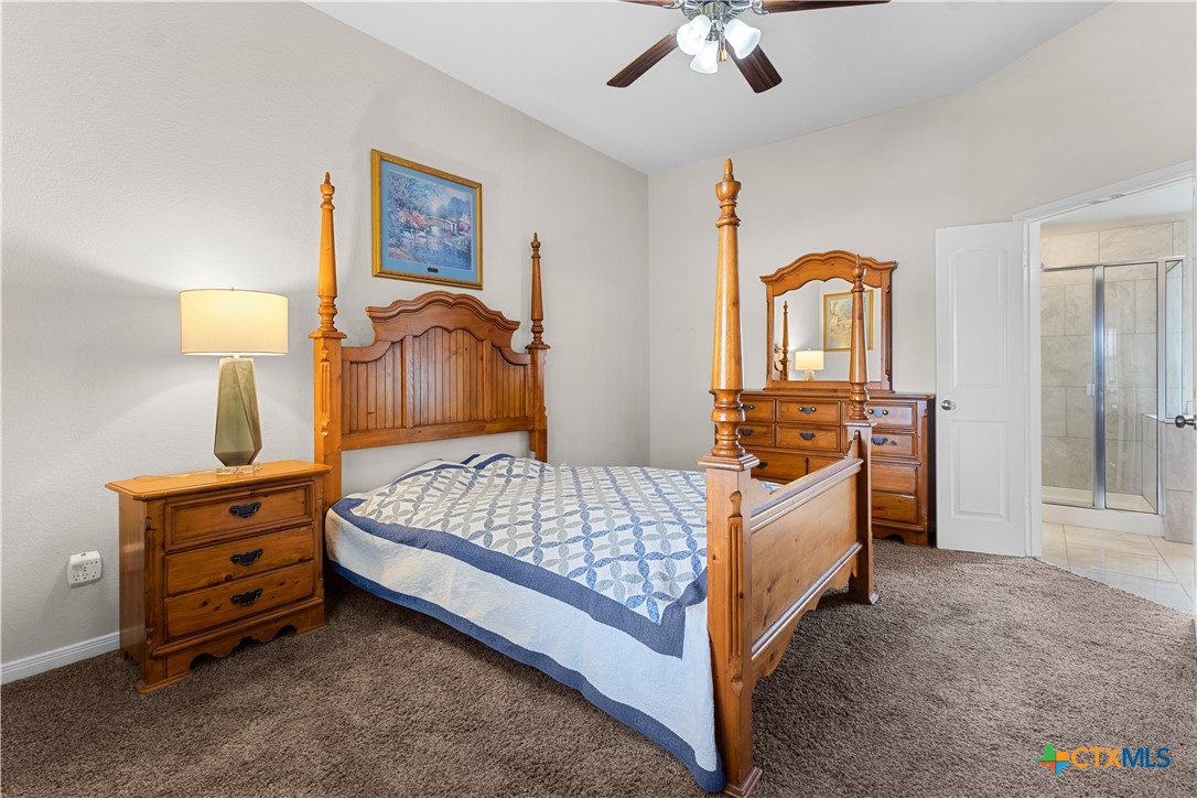3615 Addison Street Killeen, TX 76542 - Photo 23 of 47 a bedroom with a bed and a lamp on table