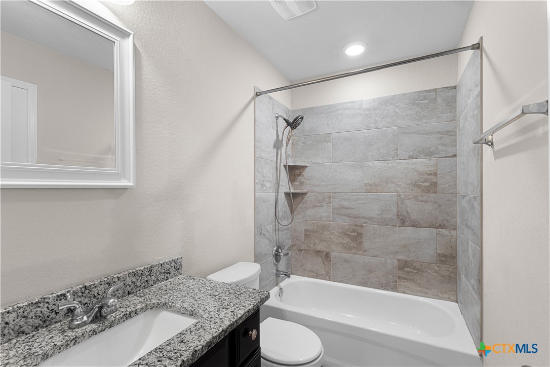 3615 Addison Street Killeen, TX 76542 - Photo 35 of 47 a bathroom with a granite countertop bathtub shower sink and toilet