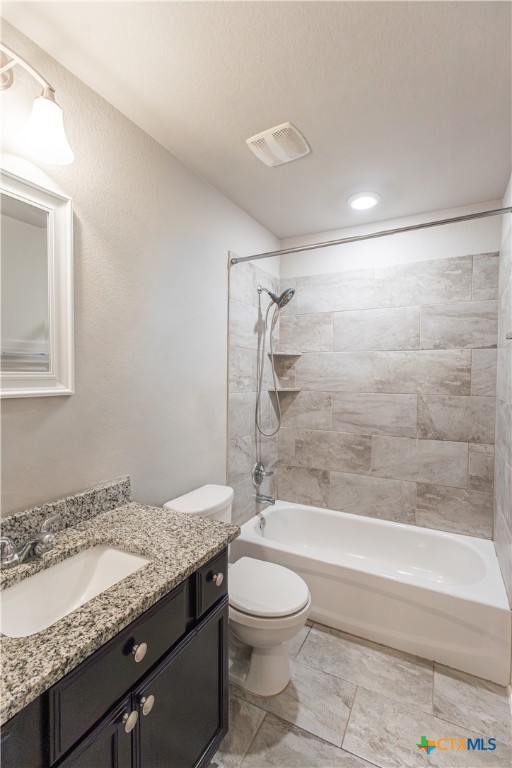 3615 Addison Street Killeen, TX 76542 - Photo 36 of 47 a bathroom with a granite countertop sink a toilet and bathtub
