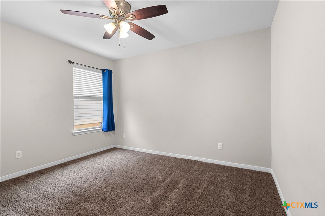 3615 Addison Street Killeen, TX 76542 - Photo 39 of 47 an empty room with a window and a ceiling fan