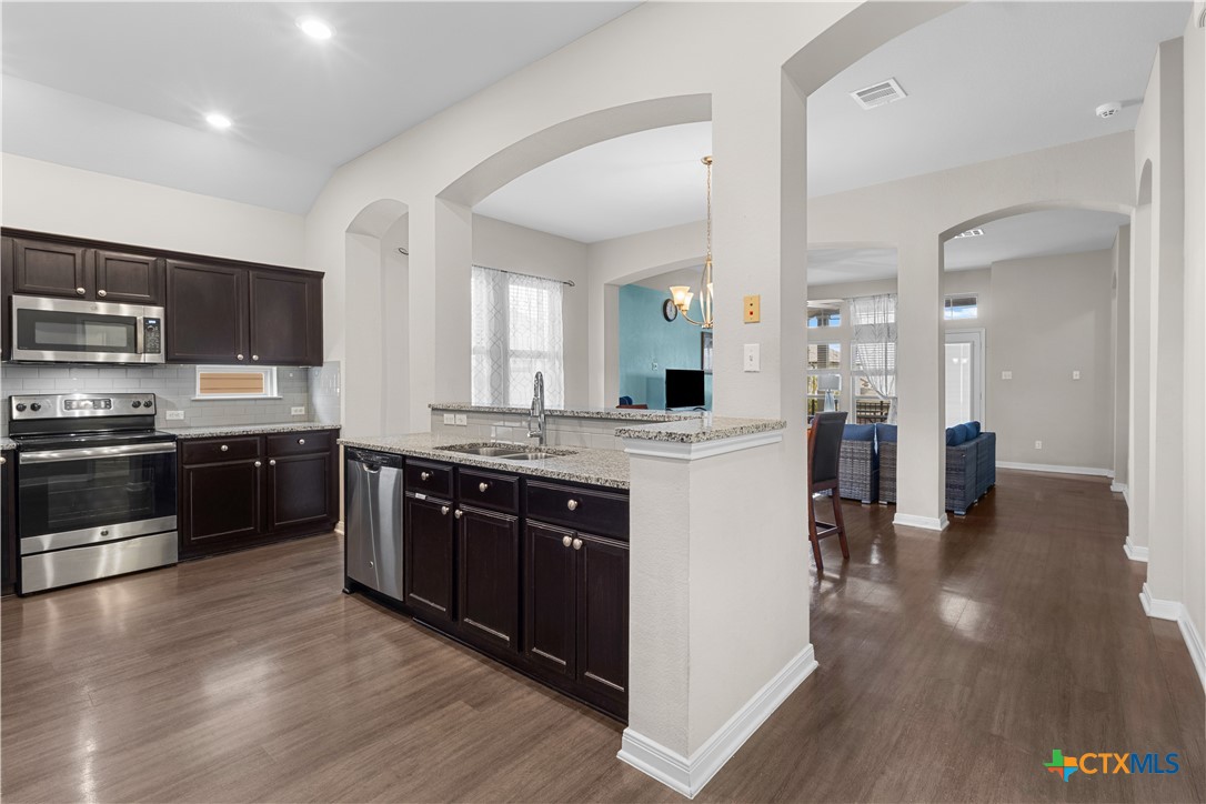 3615 Addison Street Killeen, TX 76542 - Photo 9 of 47 a large kitchen with stainless steel appliances and wooden cabinets